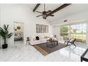 Bright living room with high ceilings, wood beams, marble floors, and modern furnishings creating an elegant space at 2919 Shannon Drive, Punta Gorda, FL 33950