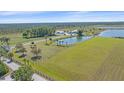 Beautiful waterfront property with a home, lake, and sprawling green fields at 29527 Leah Rd, Punta Gorda, FL 33982