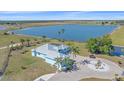 Expansive aerial view showcasing the light-blue house and pristine landscaping on a waterfront property at 29527 Leah Rd, Punta Gorda, FL 33982