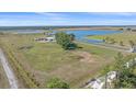 Picturesque aerial view of a large property with lush greenery and a tranquil lake at 29527 Leah Rd, Punta Gorda, FL 33982