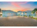 Attractive two-story home showcasing a spacious driveway leading to an attached three-car garage at 29527 Leah Rd, Punta Gorda, FL 33982