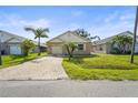 Charming single-story home with a brick paver driveway and well-maintained lawn and landscaping at 3362 Howell Pl, Sarasota, FL 34232