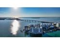 Stunning aerial view of condos on the water, with a bridge visible in the background on a sunny day at 350 Golden Gate Pt # 61, Sarasota, FL 34236