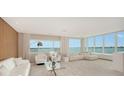 Bright living room with ample seating, floor to ceiling windows and serene water views at 350 Golden Gate Pt # 61, Sarasota, FL 34236