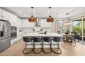 Spacious kitchen featuring a large center island with seating and stainless steel appliances at 3621 Wild Blossom Pl, Parrish, FL 34219