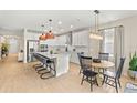 Bright, modern kitchen with stainless steel appliances, a large island, and an adjacent dining area at 3621 Wild Blossom Pl, Parrish, FL 34219
