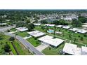 Aerial shot showcases a property with lush greenery, a community pool, and a serene neighborhood ambiance at 3641 Somerville Dr # 1506, Sarasota, FL 34232