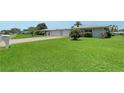 This house has a lush green lawn and a driveway leading to a two-car garage, complementing the home's curb appeal at 3641 Somerville Dr # 1506, Sarasota, FL 34232