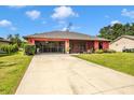 Single-Gathering home with a front lawn and a screened garage at 4145 W Price Blvd, North Port, FL 34286