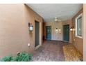 Townhome entryway featuring individual unit doors, brick pavers, overhead lighting, and stucco walls at 4235 Overture Cir # 4235, Bradenton, FL 34209