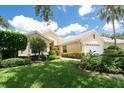 Inviting single-story home with lush landscaping, a well-maintained lawn, and a cozy, welcoming curb appeal at 4374 Mirabella Cir, Bradenton, FL 34210
