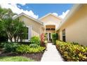 Inviting front entrance with lush landscaping, a walkway, and a welcoming double-door entry at 4374 Mirabella Cir, Bradenton, FL 34210