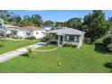 Well-kept single-story home with a lush green lawn and mature trees providing shade and curb appeal at 5028 Oxford N Ave, St Petersburg, FL 33710