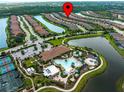 Aerial view of the community showcasing the resort-style pool, tennis courts and surrounding lakes at 5364 Salcano St, Sarasota, FL 34238