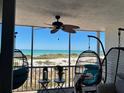 Relaxing screened balcony featuring comfortable seating and stunning ocean views, perfect for enjoying the coastal breeze at 555 The Esplanade N # 202, Venice, FL 34285