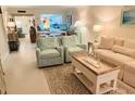 Inviting living room with comfortable seating, a stylish coffee table, and an open layout to the kitchen at 555 The Esplanade N # 202, Venice, FL 34285