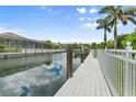Deep water canal with dock in a beautiful backyard setting and lush landscaping at 584 Mast Dr, Bradenton, FL 34208
