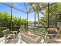 Cozy outdoor living space featuring comfortable seating around a stone fire pit at 584 Mast Dr, Bradenton, FL 34208