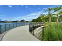 Scenic lakeside walkway with metal railing provides stunning views in this beautiful community at 6224 Isla Del Ray Ave, Sarasota, FL 34240