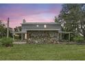 Two-story home with a stone exterior accent, featuring a covered porch on a well-maintained lawn at 6633 Old Ranch Rd, Sarasota, FL 34241