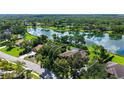 Aerial view of home surrounded by mature trees next to a pond at 7426 Weeping Willow Blvd, Sarasota, FL 34241