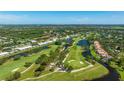 Aerial view showcasing lush golf course, picturesque ponds, and beautiful landscaping at 7461 W Country Club N Dr # 206, Sarasota, FL 34243