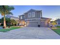 Lovely two-story home featuring a well-manicured lawn, a three-car garage, and a welcoming front porch at 7915 115Th E Ave, Parrish, FL 34219