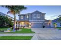Beautiful two-story home featuring a well-manicured lawn, a three-car garage, and a welcoming front porch at 7915 115Th E Ave, Parrish, FL 34219