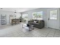 Bright living room featuring tile flooring, a comfortable sofa, and modern décor with plenty of natural light at 111 66Th Street E Ct, Bradenton, FL 34208