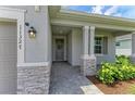 An inviting entryway with stone pillars and manicured landscaping at 11327 Burgundy Dr, Venice, FL 34293