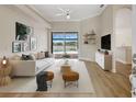 Bright living room showcasing wood floors and sliding glass doors to the pool and lake at 11328 Rivers Bluff Cir, Lakewood Ranch, FL 34202