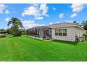 Spacious backyard with a screened-in pool and spa, lush green lawn and exterior view of the single Gathering home at 11508 30Th E Cv, Parrish, FL 34219