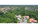 Aerial view of beautiful community featuring lush, mature landscaping, lakes, and golf course at 13203 Lost Key Pl, Lakewood Ranch, FL 34202