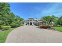 Charming home with a paver driveway and lush landscaping at 13203 Lost Key Pl, Lakewood Ranch, FL 34202