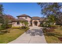 Charming two-story home with a large driveway, mature trees, and manicured landscaping at 14901 17Th E Ave, Bradenton, FL 34212