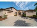 Stunning single-story home with a spacious driveway, attached garage, and lush landscaping at 14901 17Th E Ave, Bradenton, FL 34212