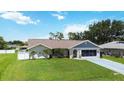 Lovely single-story home displaying a lush green lawn, and attached garage, enhancing its appeal at 1498 Truval Ter, Port Charlotte, FL 33952