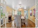 Cozy dining room featuring a fireplace, hardwood floors, and a wicker dining set at 1732 6Th St, Sarasota, FL 34236