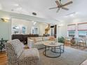 Open-concept living room showcasing hardwood floors, a ceiling fan, and neutral furniture at 1732 6Th St, Sarasota, FL 34236