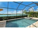 Screened pool and spa overlooking a serene lake, perfect for relaxation and enjoying the beautiful views at 17320 Polo Trl, Bradenton, FL 34211