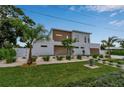 Modern house with neat landscaping, stone driveway, and a two-car garage at 2124 Clematis Pl, Sarasota, FL 34239