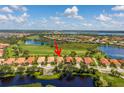 Stunning aerial view of a residential area featuring picturesque lakes, a golf course, and beautiful single-Gathering homes at 234 Padova Way, North Venice, FL 34275