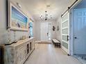Bright foyer with light wood flooring, decorative chandelier, and an accent painting for a warm and inviting feel at 336 165Th Ne Ct, Bradenton, FL 34212