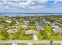 Aerial view of a waterfront property with a canal, nestled in a picturesque community with water access and lush landscaping at 336 Highland Shores Dr, Ellenton, FL 34222