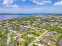 Aerial view of the waterfront property with a canal, situated in a scenic community with lush greenery and water views at 336 Highland Shores Dr, Ellenton, FL 34222