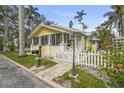 Charming cottage with a white picket fence, lush lawn and a beautiful vintage-style lamppost at 403 29Th Nw St, Bradenton, FL 34205