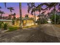 Charming yellow cottage-style home featuring a screened porch and well-maintained landscaping at 403 29Th Nw St, Bradenton, FL 34205