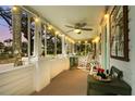 Inviting screened porch featuring comfortable seating, string lights, and serene outdoor views at 403 29Th Nw St, Bradenton, FL 34205