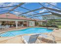 Relaxing screened-in pool area with a spa, lounge chairs, and outdoor dining space, perfect for enjoying sunny days at 4330 Presidential Avenue E Cir, Bradenton, FL 34203