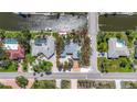 Aerial view of a waterfront home on a canal lot with tropical landscaping and easy access to nearby beaches at 5572 Shadow Lawn Dr, Sarasota, FL 34242